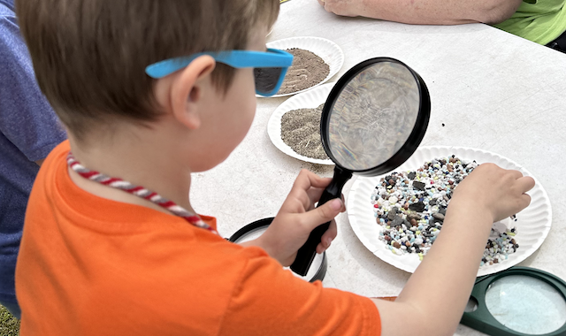 Youth looking through magnifying glass
