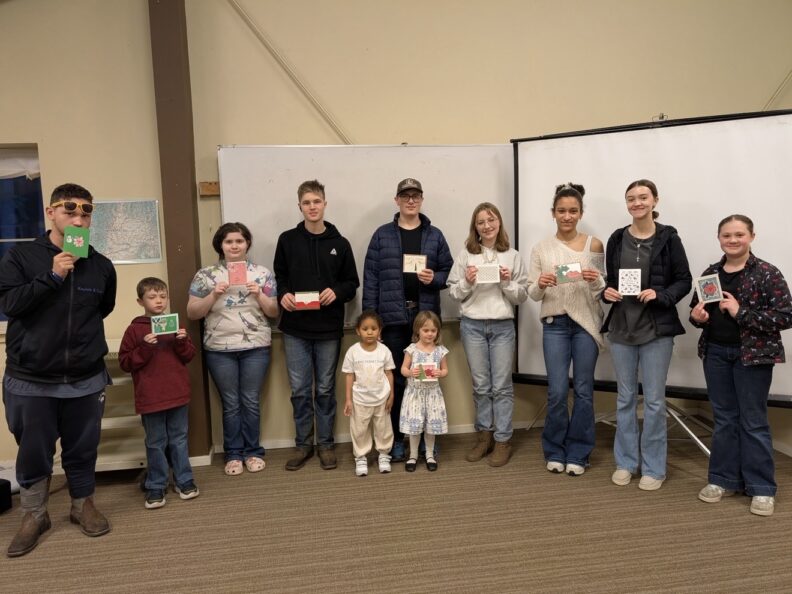 Gig Harbor 4-H Club members showing Valentin's Day cards they had made for giving to elderly in a senior living home.