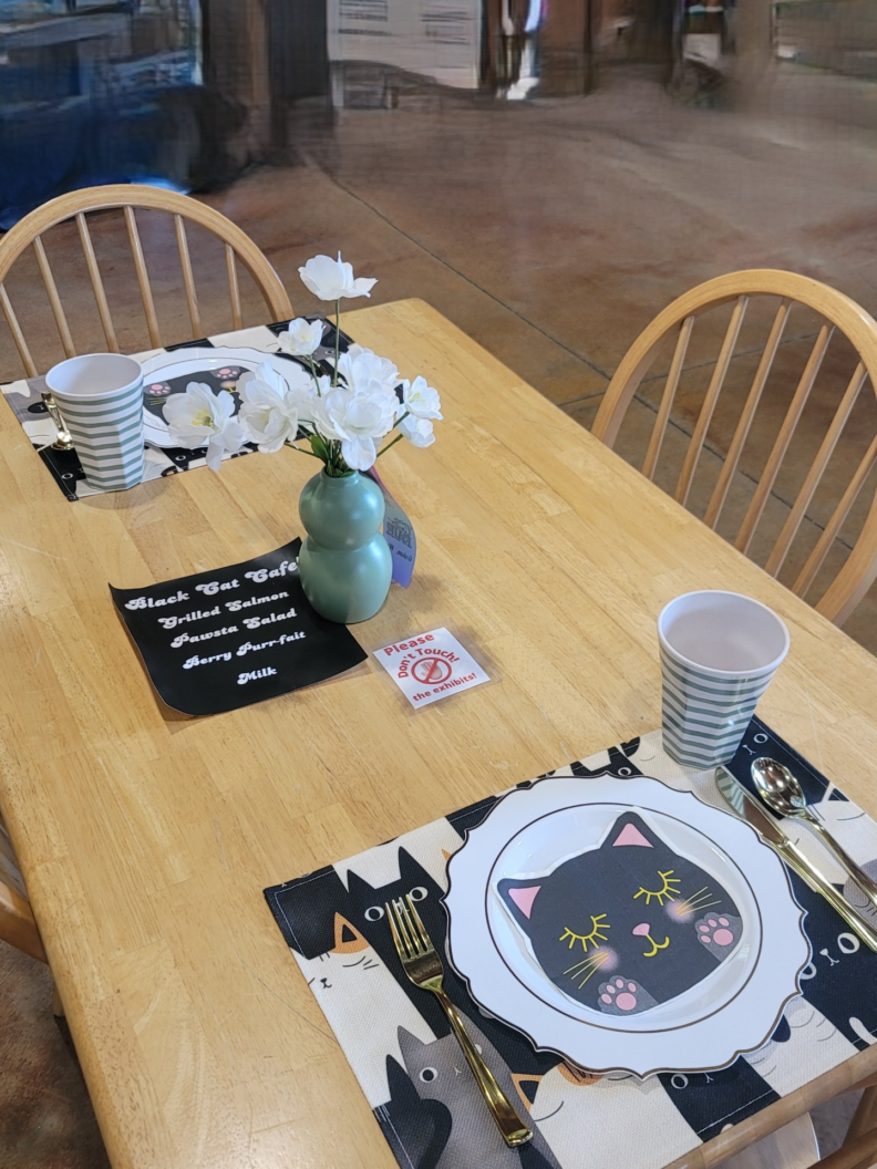 A table setting activity with a cat theme to it.