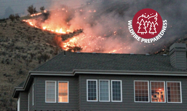 Home with wildfire burning in the background