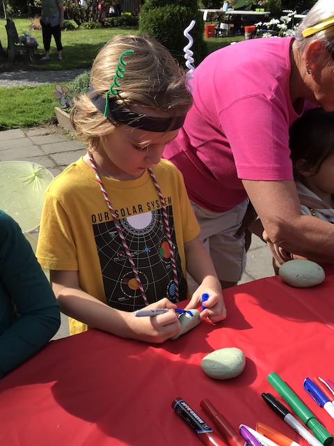 Youth coloring a rock