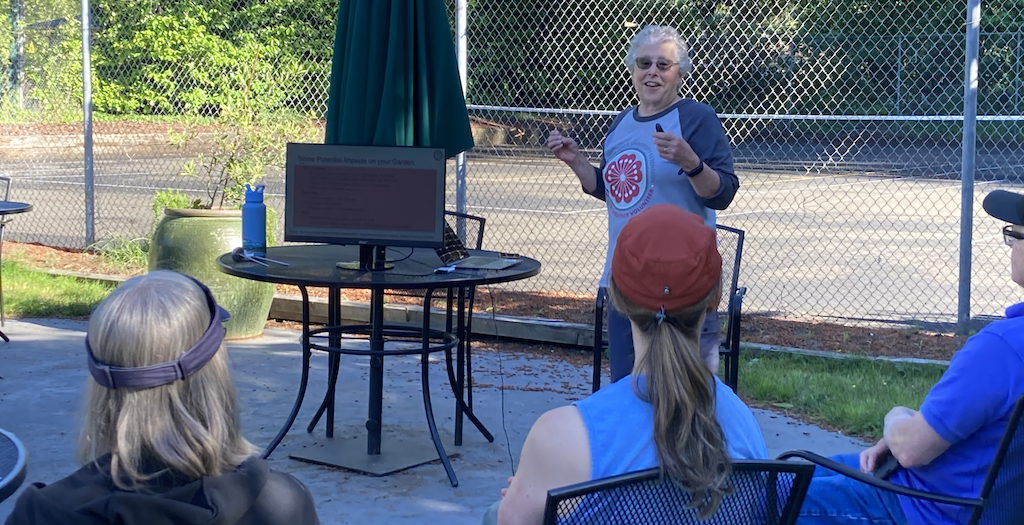 Master Gardener presenting outdoors to a group of people