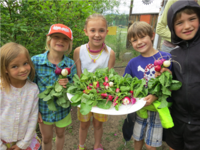 Photo of children with garden harvest