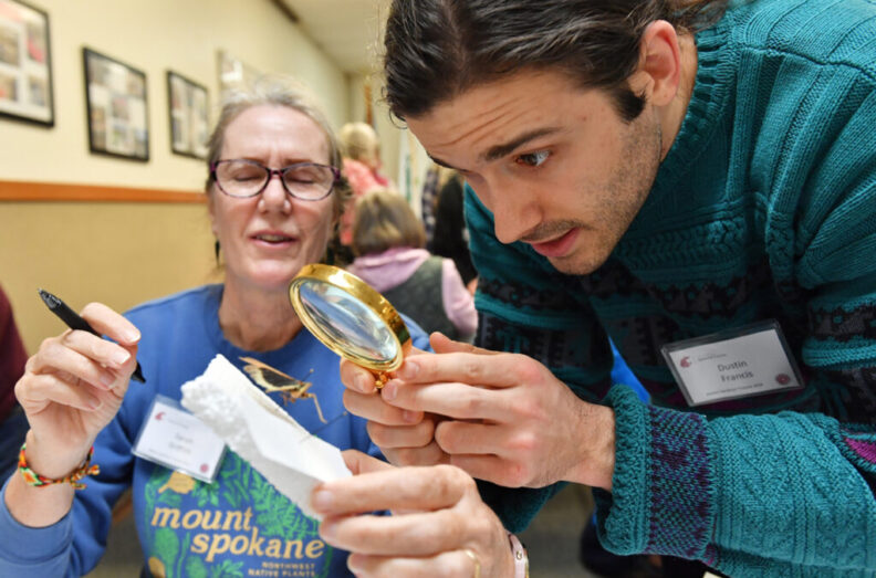 Woman helping a client identify and insect.