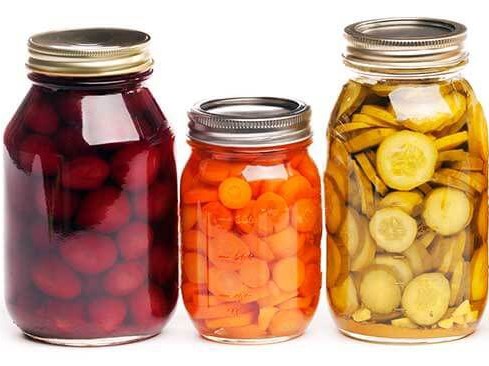 Group of homemade preserved vegetables and fruits