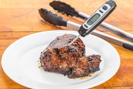 Steak with a thermometer in it. 