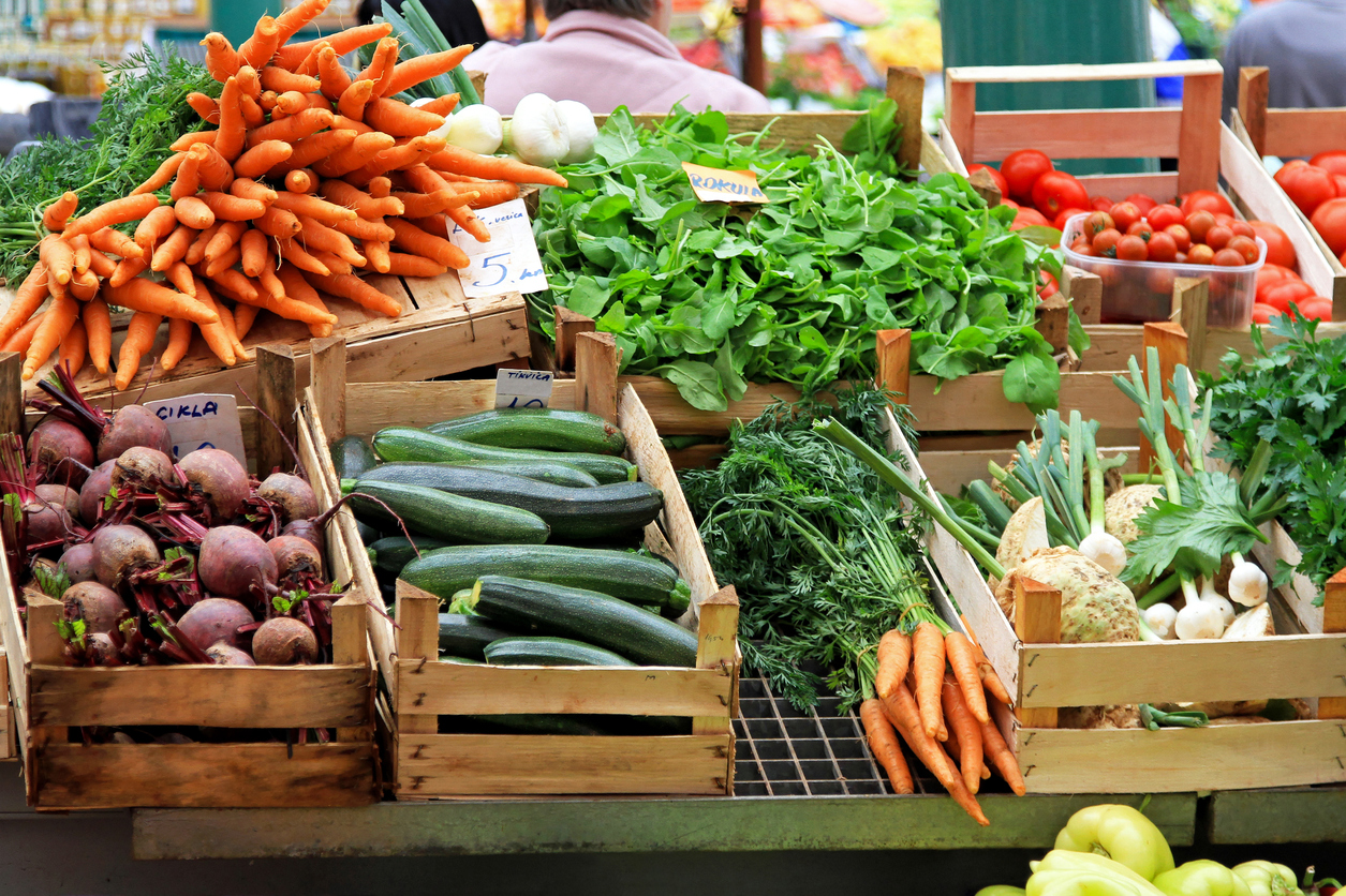 Variety of fruits and vegetables at a grocery store.