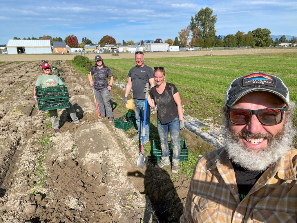 Five people working in a field.