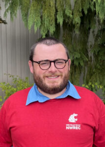 Man wearing a red shirt and glasses.