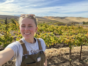 Woman taking selfie in a vineyard.