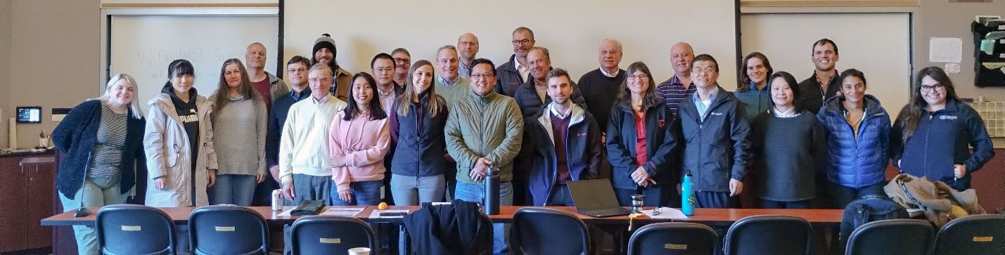 Large group of people posing indoors.