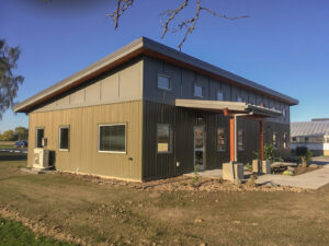 Single story building with board and batten siding.