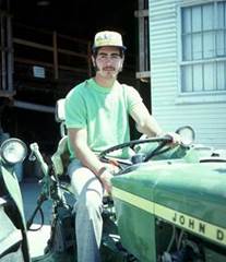 Young man seated on a tractor