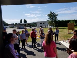 Group listens to presentation outside.