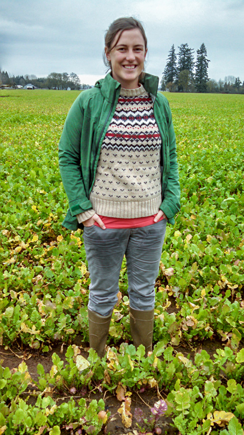 Shannon Carmody stands in a field of turnip seed.