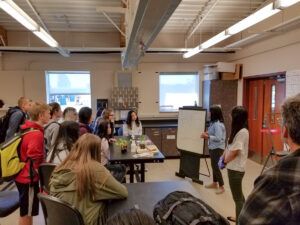 Group of students listen to a presentation.