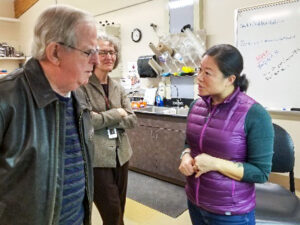 Sam Smith talks with Lydia Tymon in the Vegetable Pathology Lab at NWREC (Debbie Inglis in background).