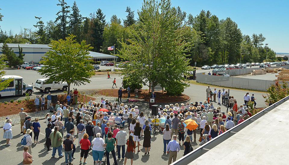 A large group of people standing in a parking lot.