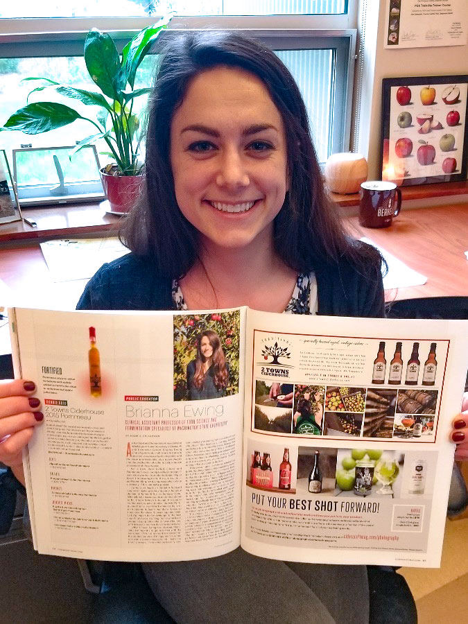 Woman holds up an open magazine.