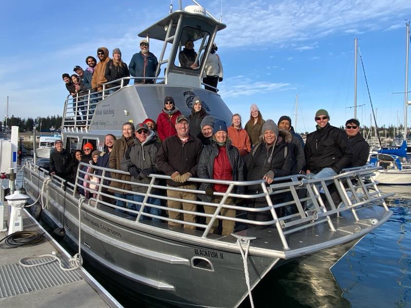 A large group of people on a boat named 'Blackfish II'.