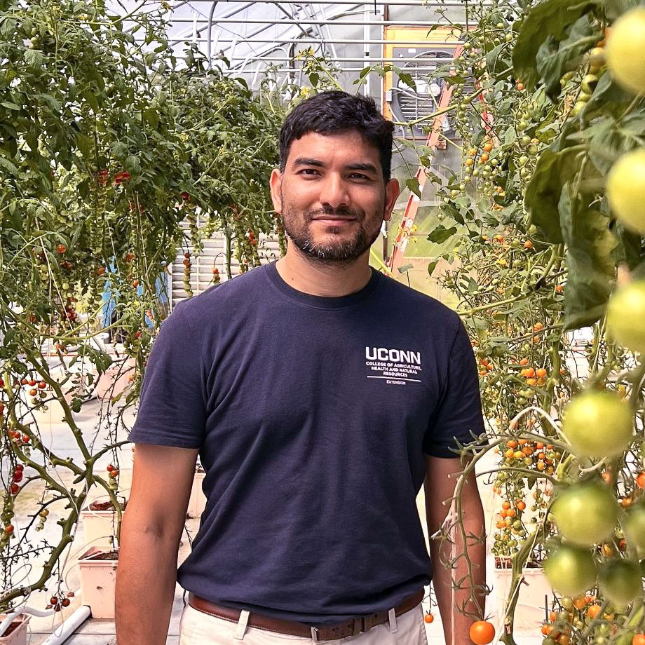 Shuresh Ghimire standing in a greenhouse.
