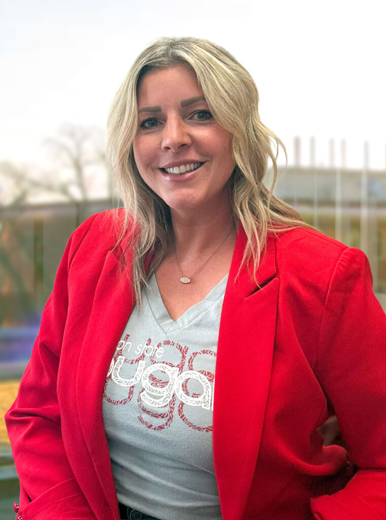 A woman in a red jacket and WSU Cougars shirt.