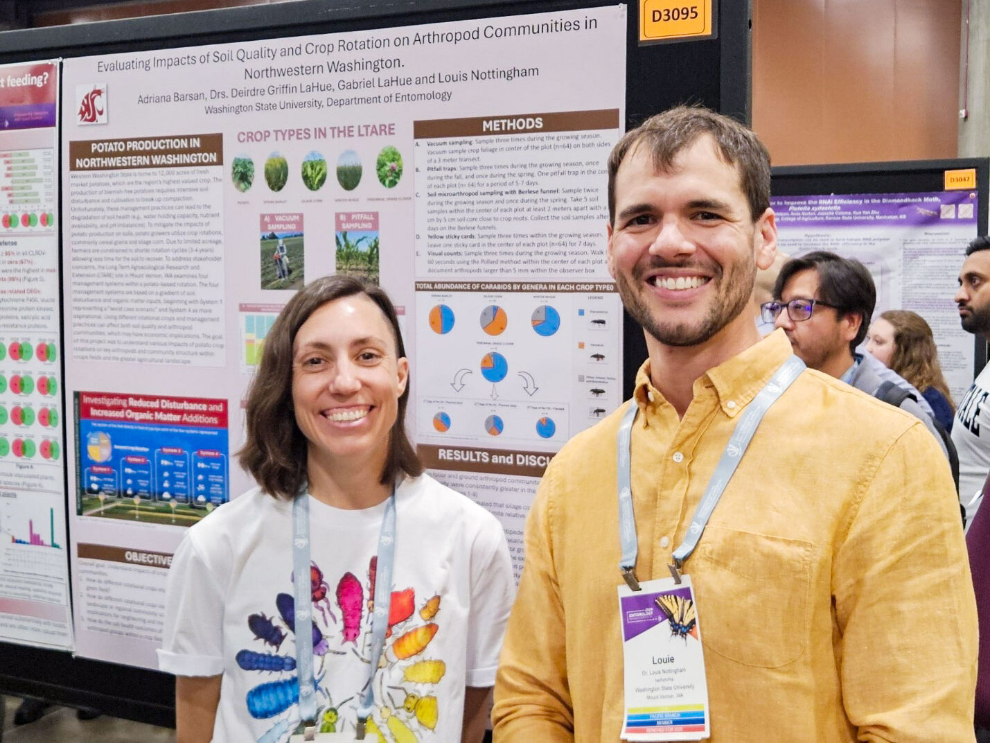 Two people standing in front of a tan poster presenting research methods and results.