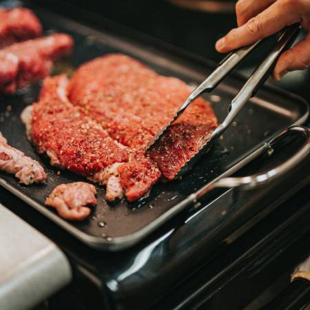 Meat being cooked on griddle