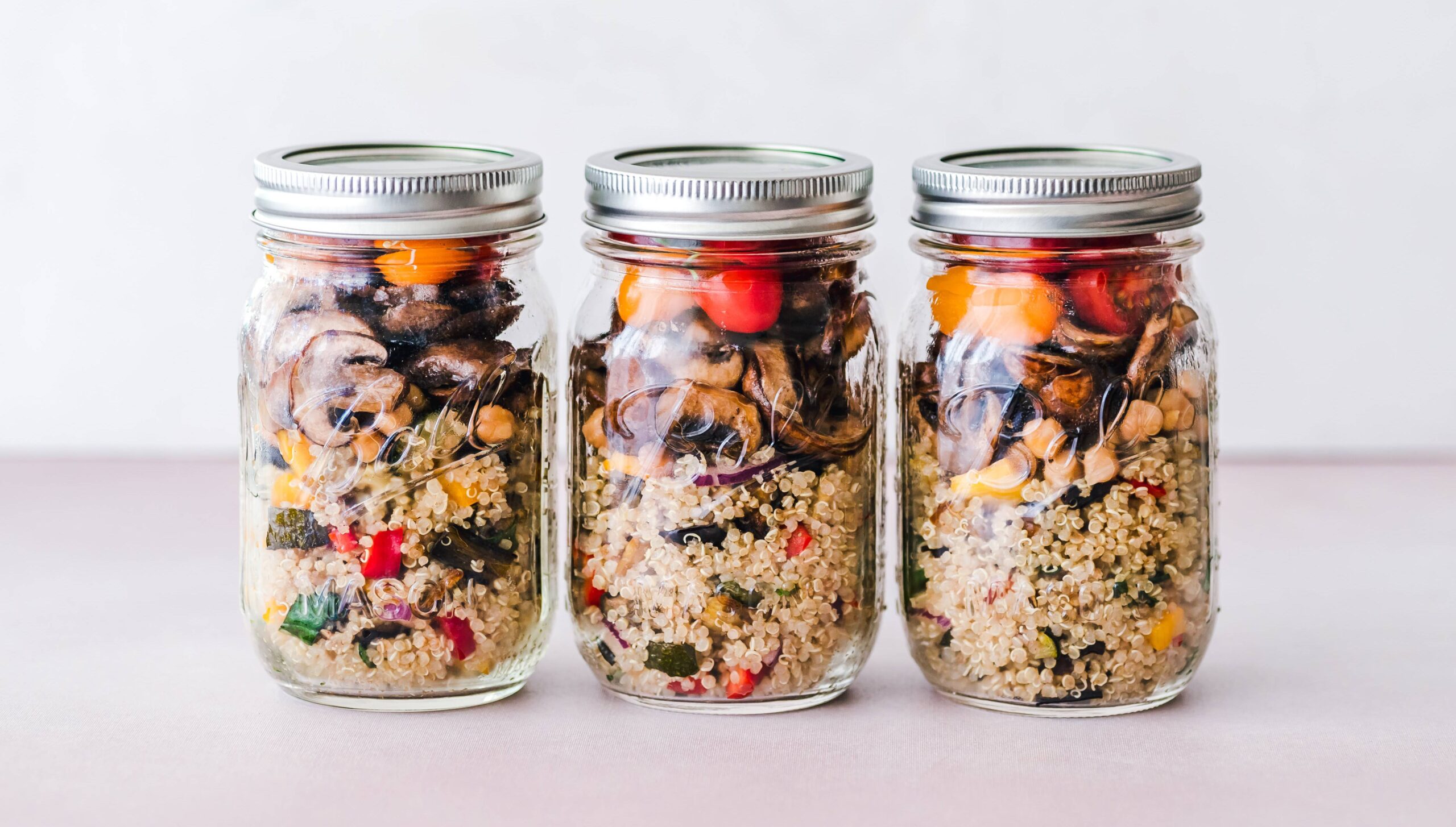 Three mason jars of canned rice and vegetables.