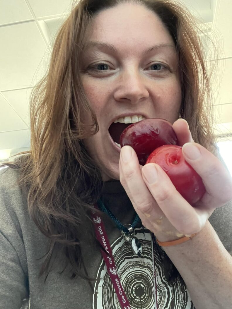 Woman eating plums