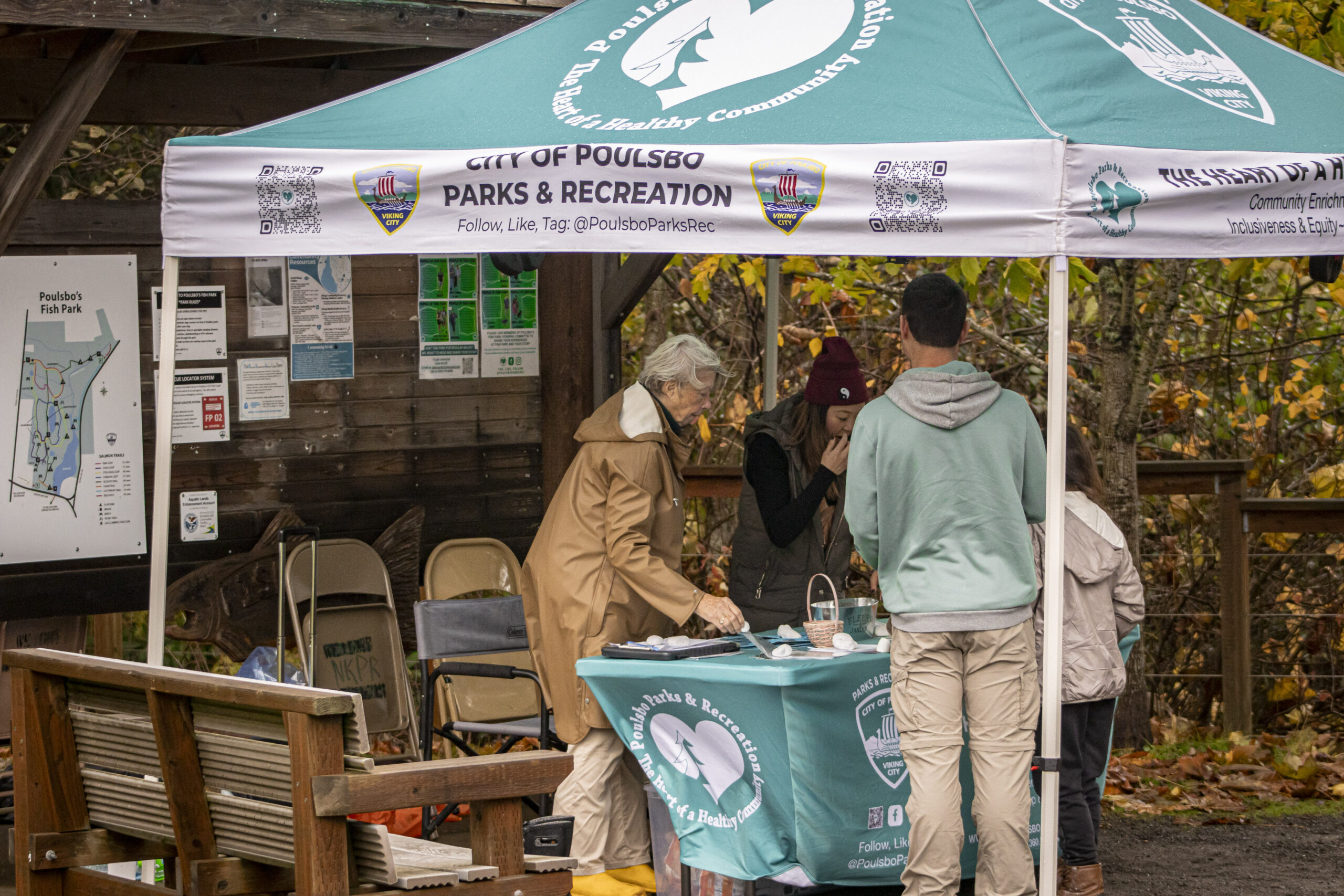 Photo of City of Poulsbo employees checking in community members at Poulsbo Fish Park for Salmon Tours event