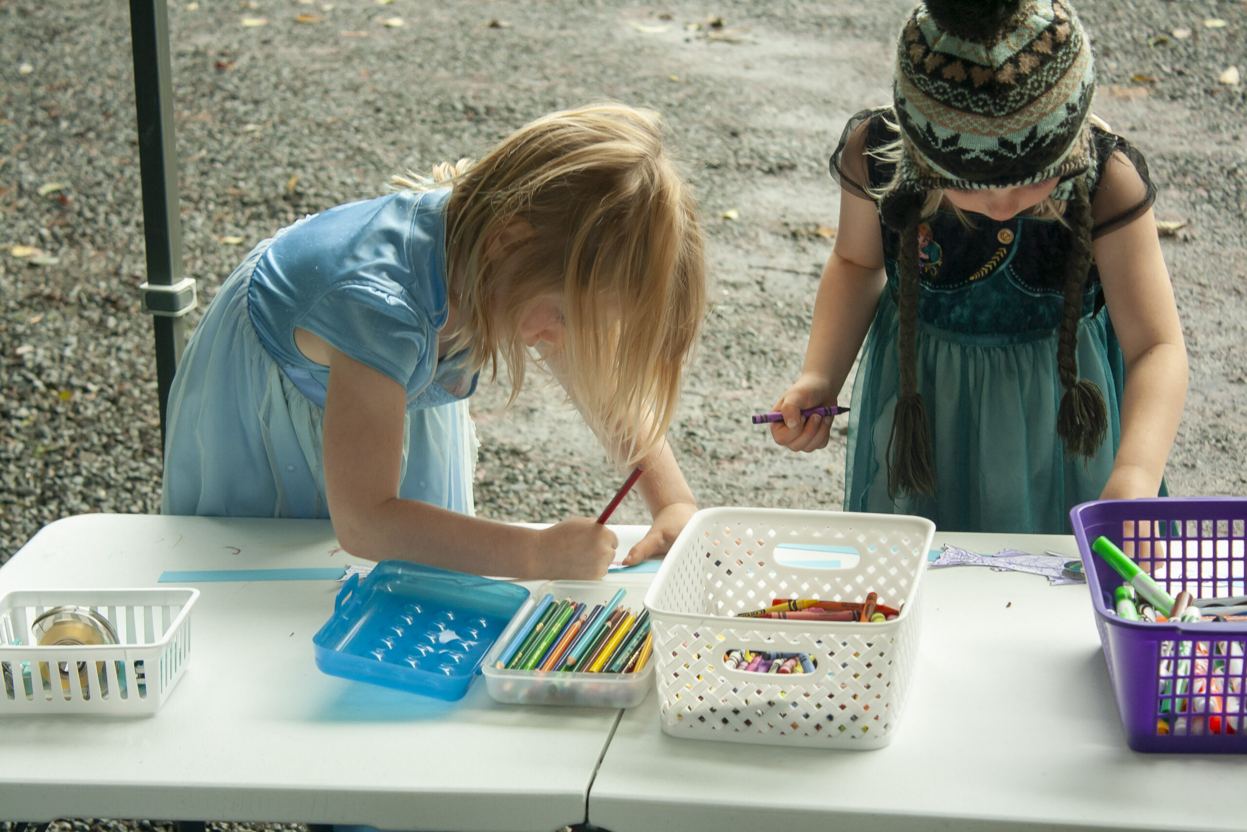 Photo of children coloring salmon at the coloring station at Salmon Tours event
