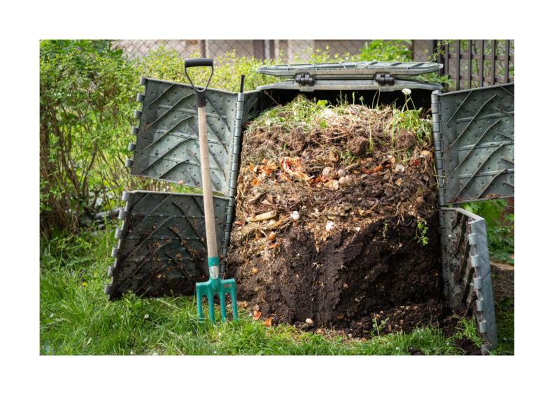 Upright plastic cylinder with side doors that are open exposing different layers to decomposing compost