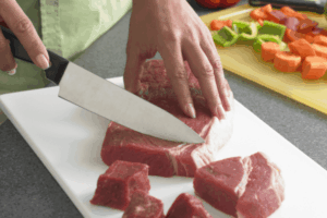 Image of cutting meat on a cutting board