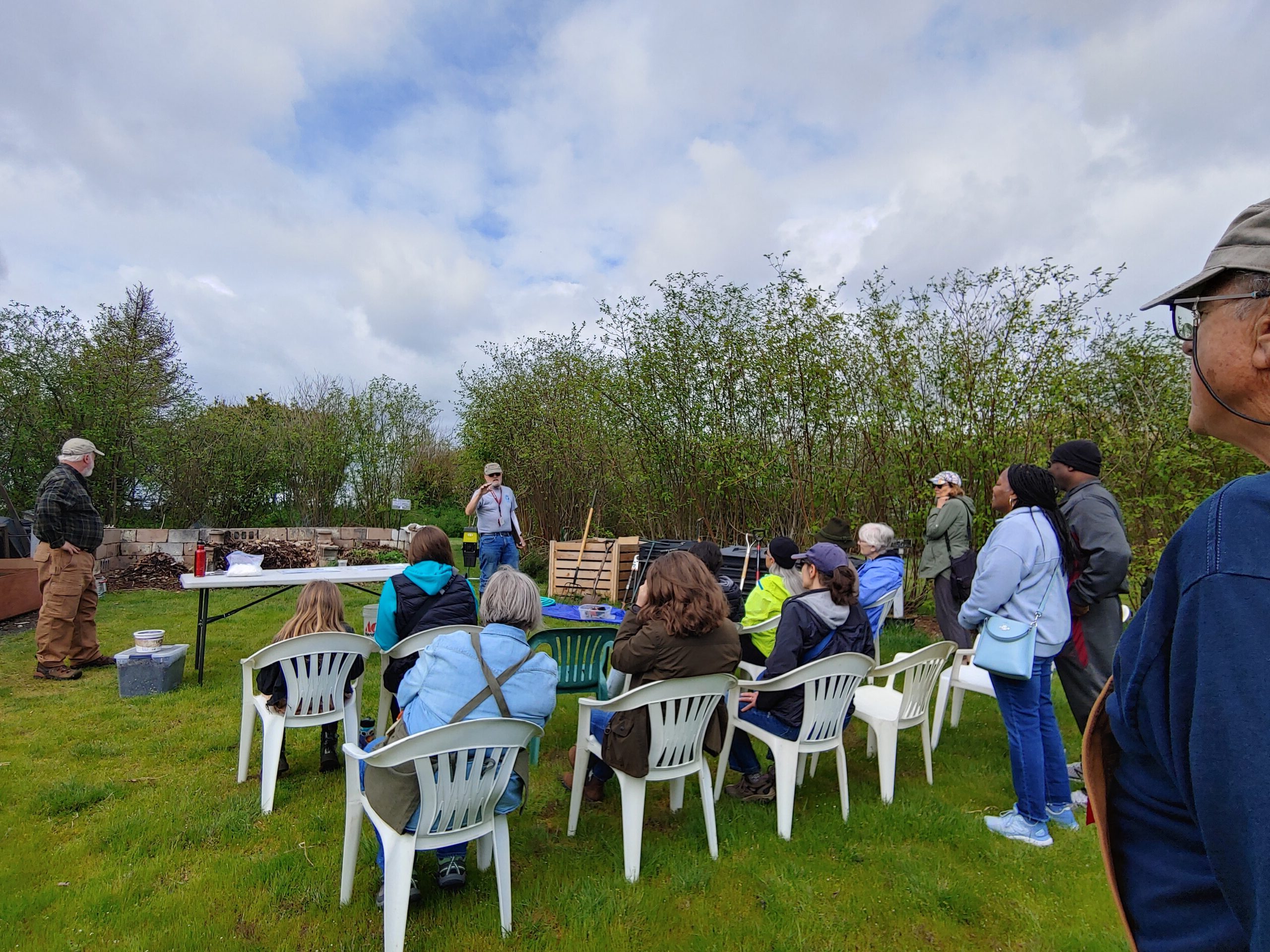 Workshop attendees sitting in chairs watching a demonstration at Closed Loop Park. 