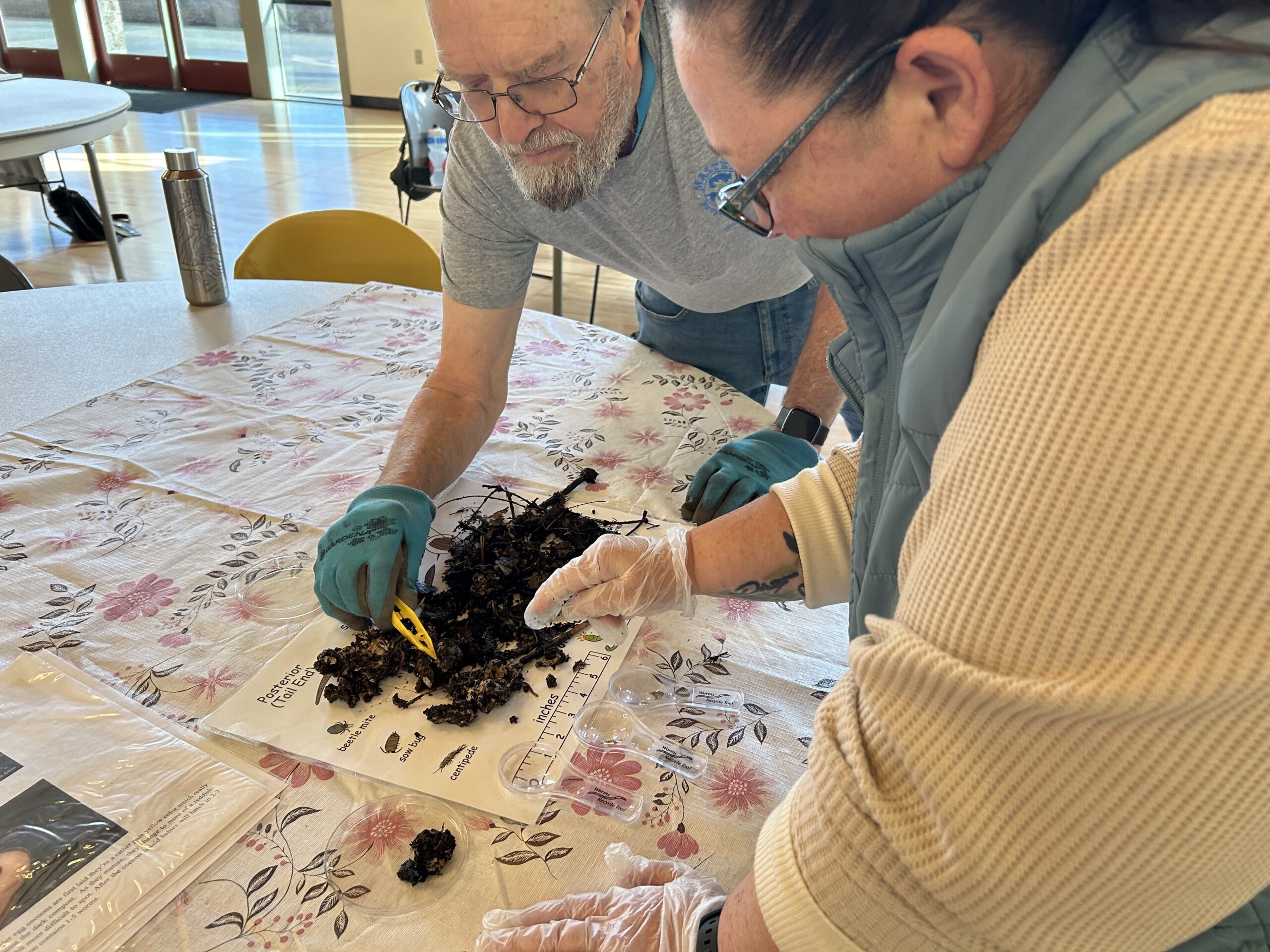 MRC trainee and certified volunteer work together to investigate contents of worm composting.