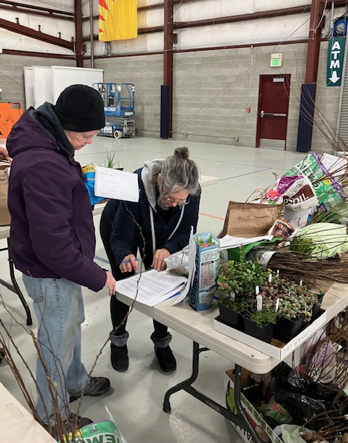 People buying plants at a native plant sale in San Juan County