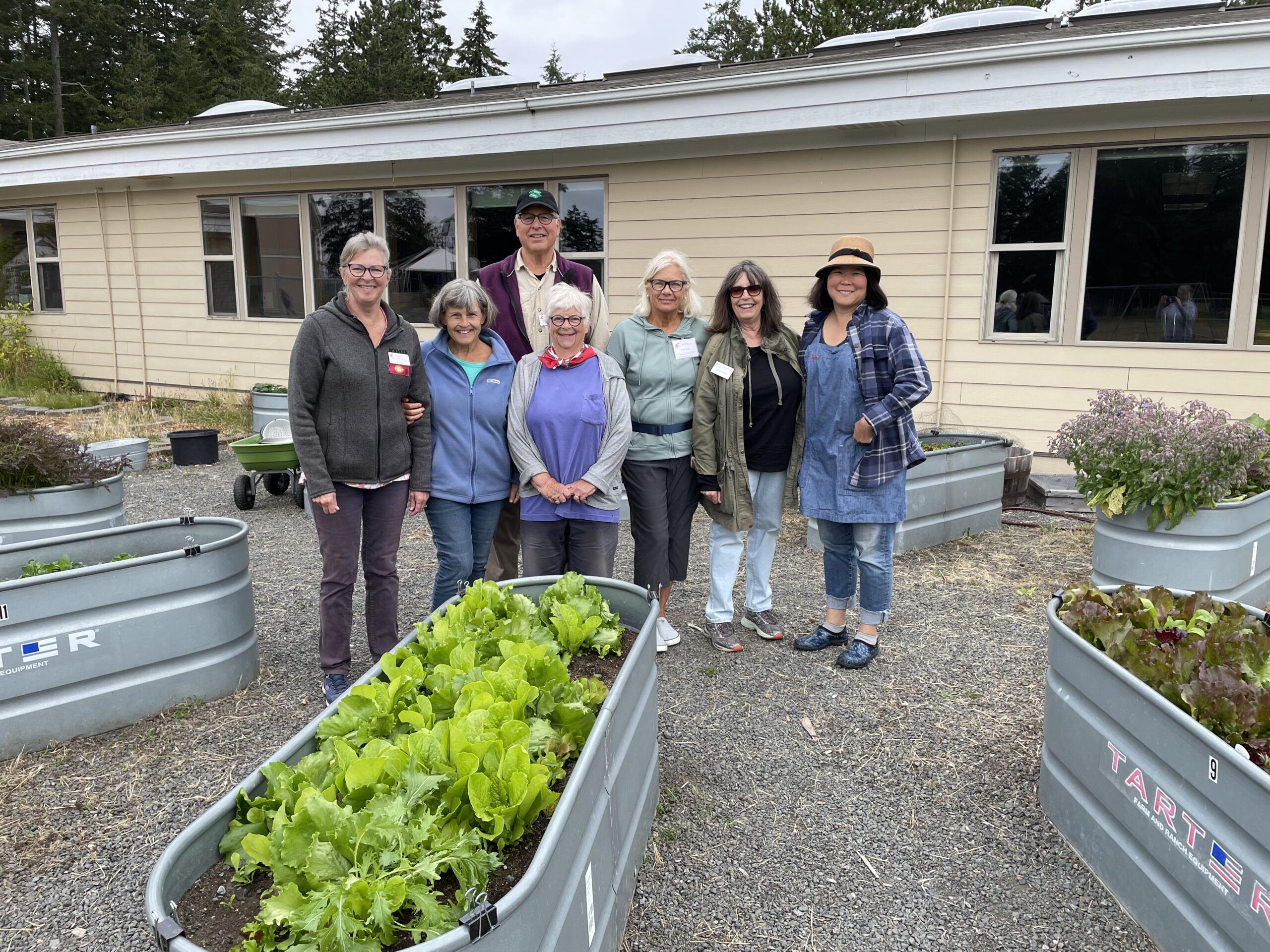 Master Gardener volunteers next to a raised garden bed
