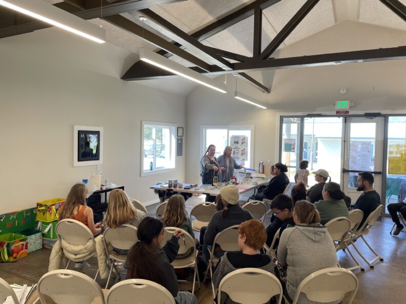 A group of youth learning about food preservation from two adult leaders.