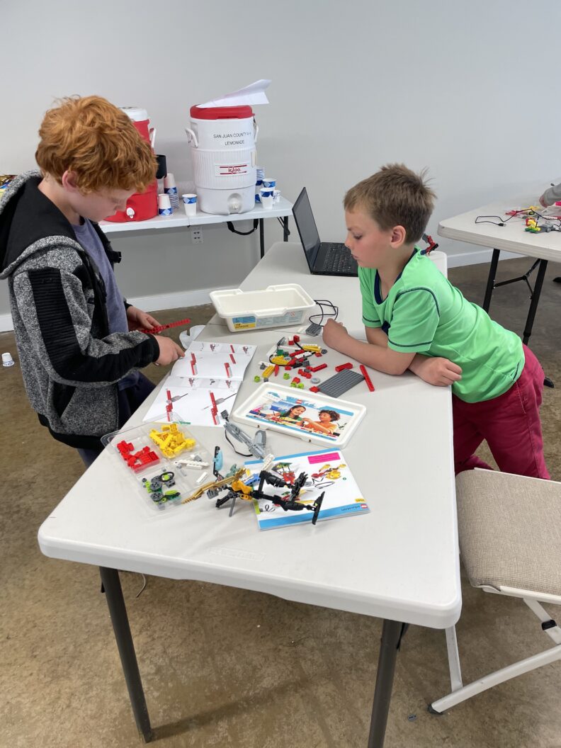 Two youth are doing lego robotics