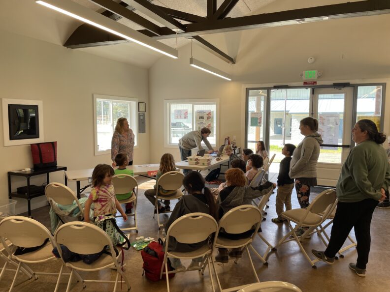 Youth learning about lego robotics from two adult leaders.
