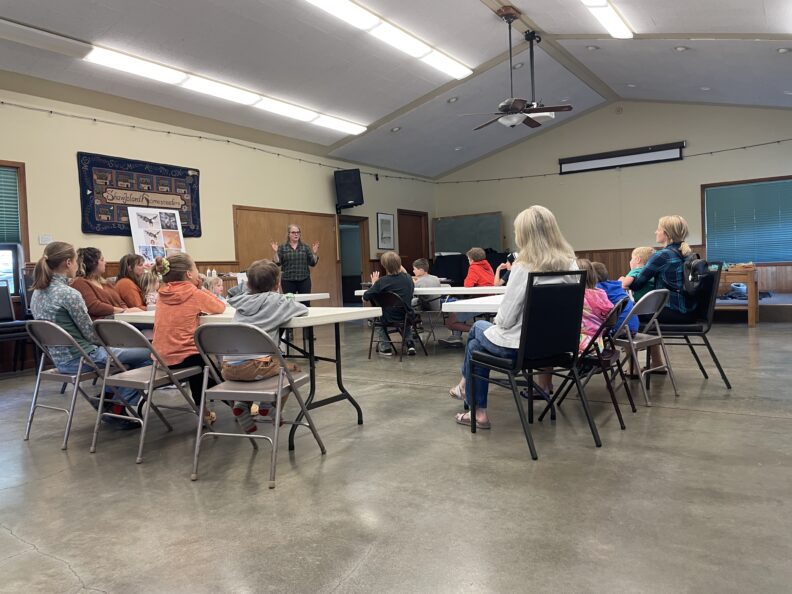Shaw island residents learn about how to make beach trash art from instructor Brook. 