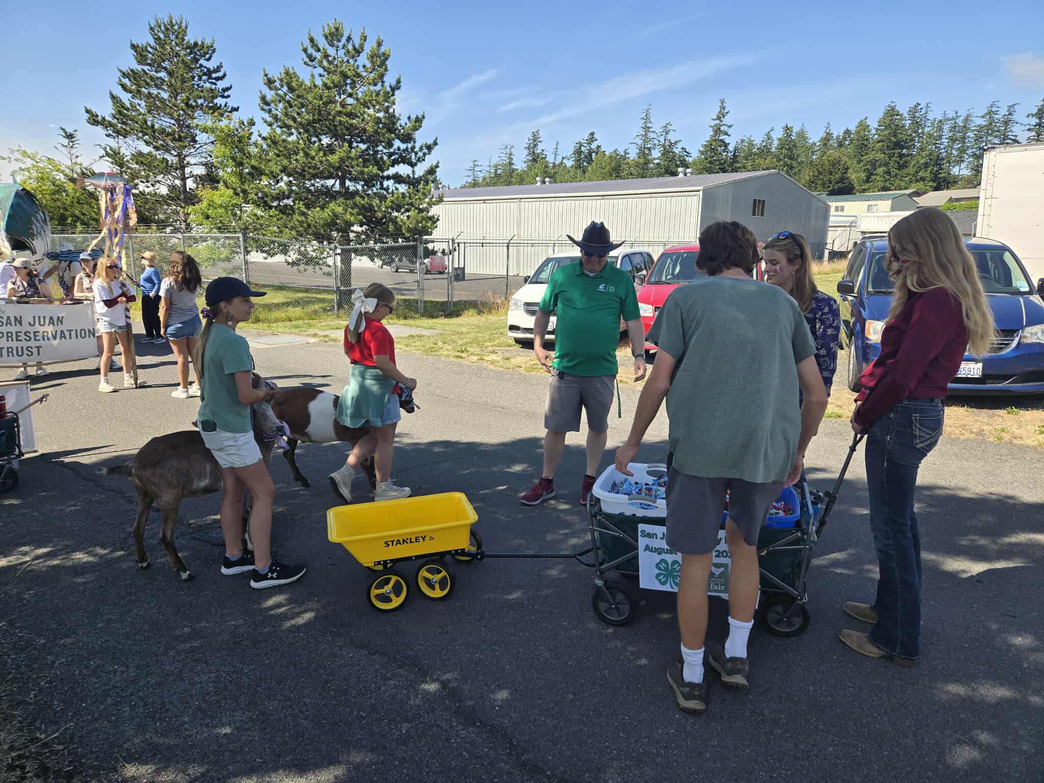 4-H members and leaders preparing for the 4th of July Parade with their wagons.