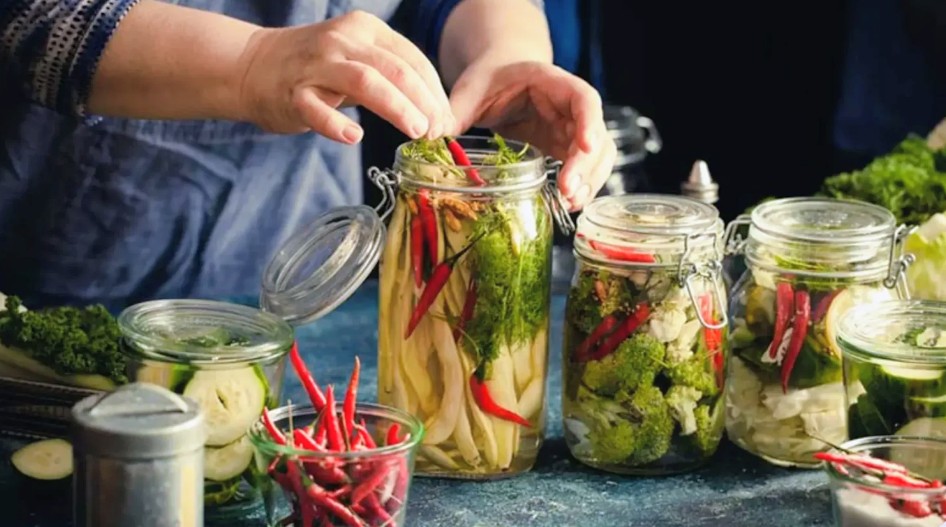 Preparing jars of vegetables for pickling