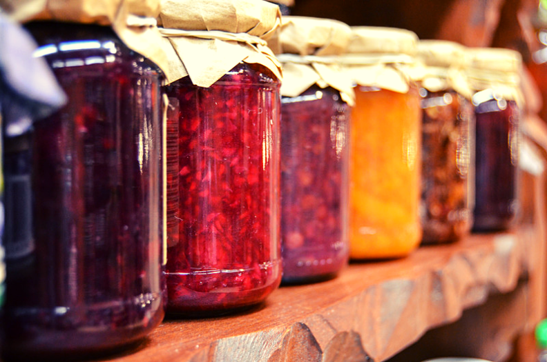 Row of colorful pressure-canned fruits and veggies