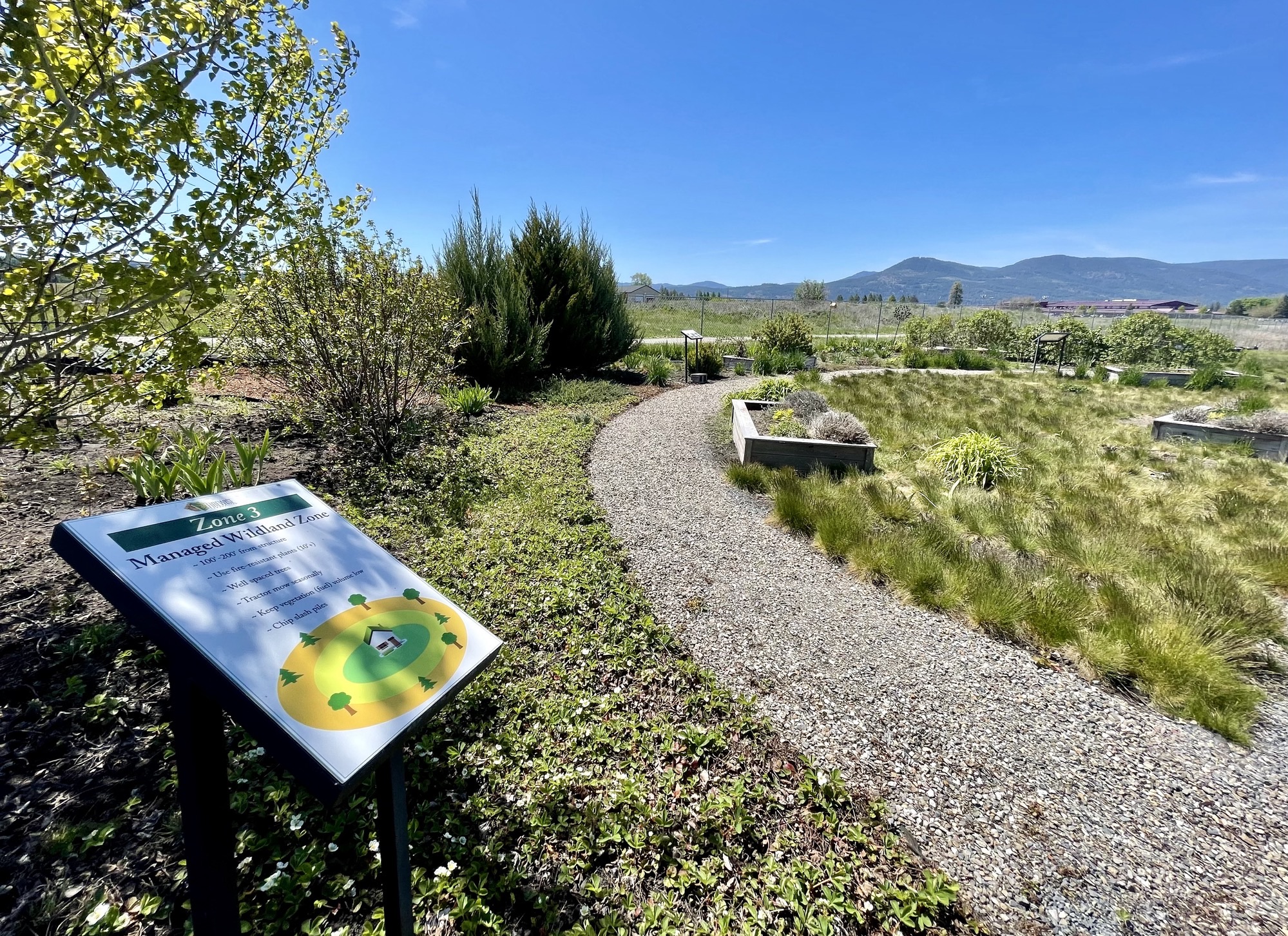 Firewise Demonstration Garden path with informational sign in foreground