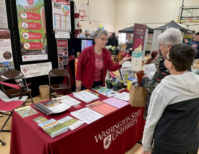 Master Gardener Mary Sety answering questions at the booth at the Chewelah Home & Garden Show