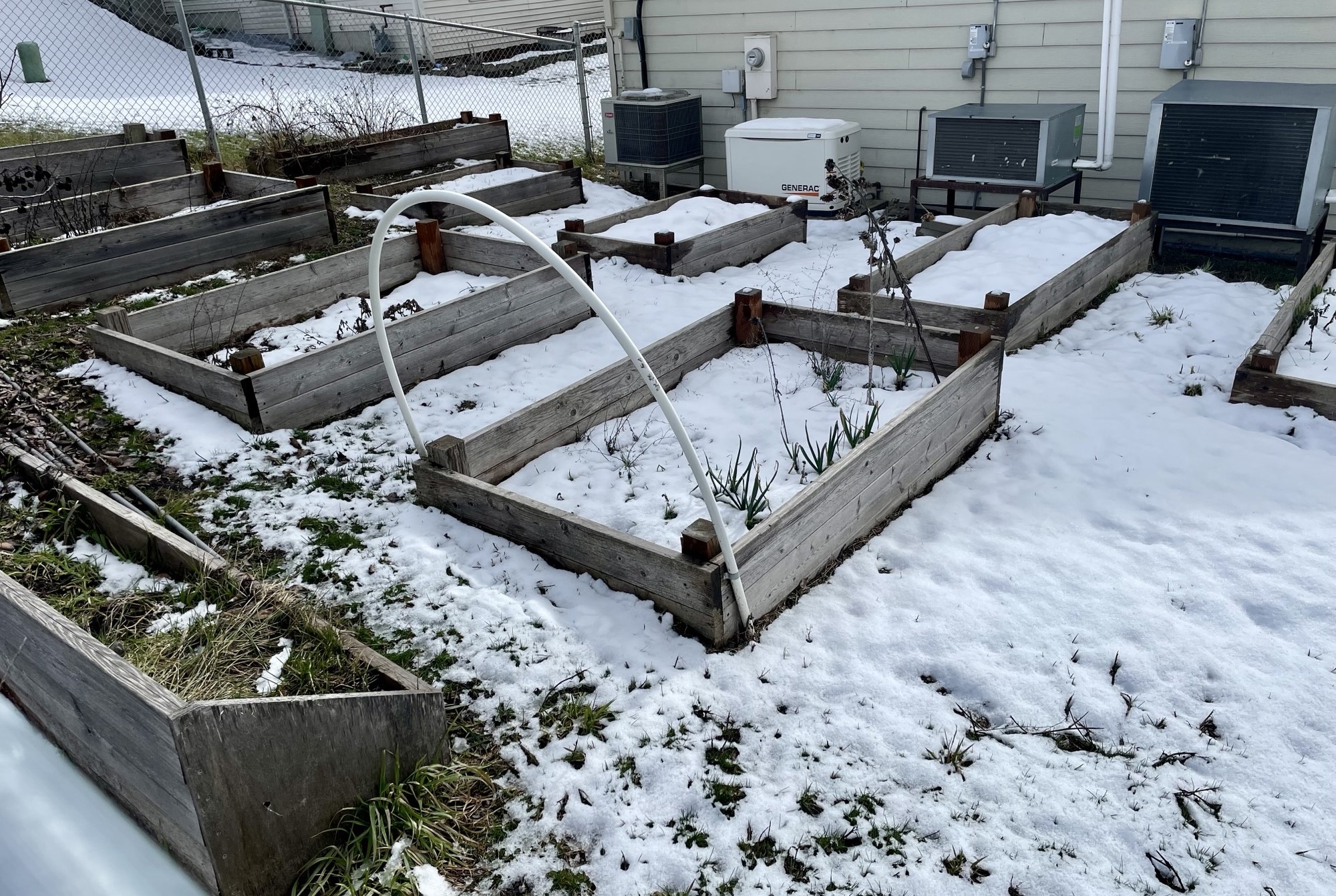 Snow-covered raised bed garden next to the Colville Food Bank building in Colville, WA