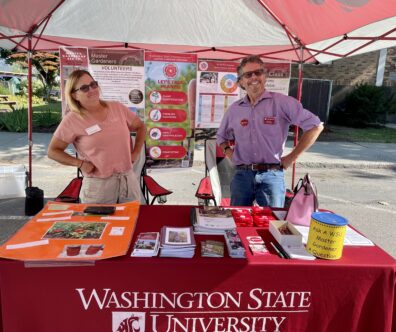 Master Gardeners Laura Patterson and Phil Teller working at the booth at Colville Farmers Market