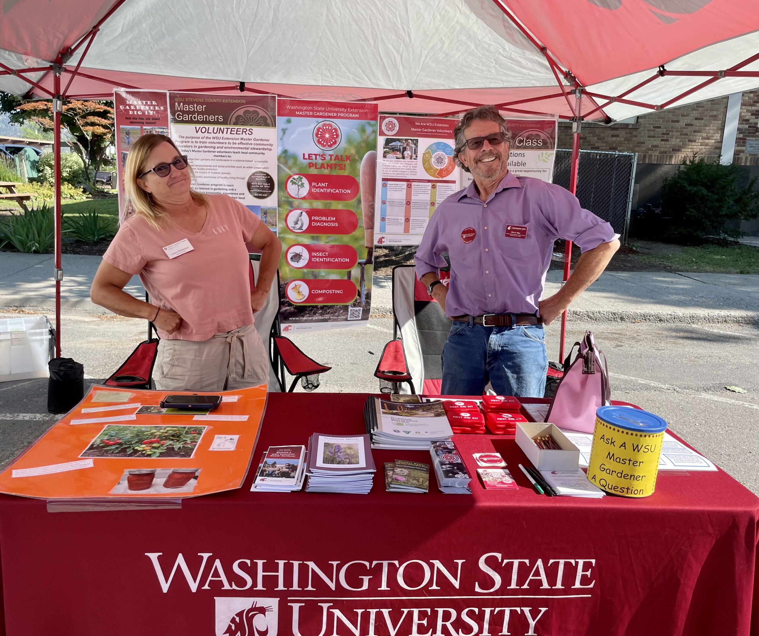 Master Gardeners Laura Patterson and Phil Teller working at the booth at Colville Farmers Market